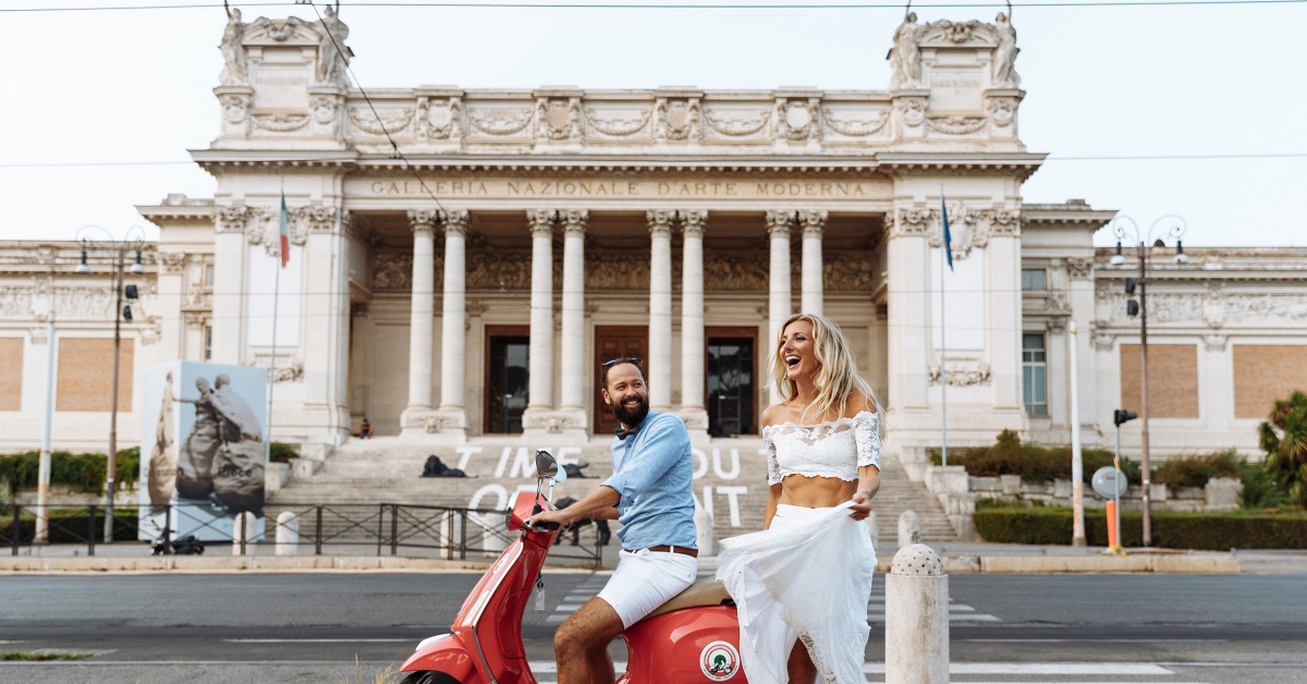 A couple on a scooter in front of the Galleria Nazionale in Rome.