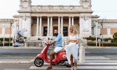 romantic holiday in Italy. Couple on vespa in Rome.