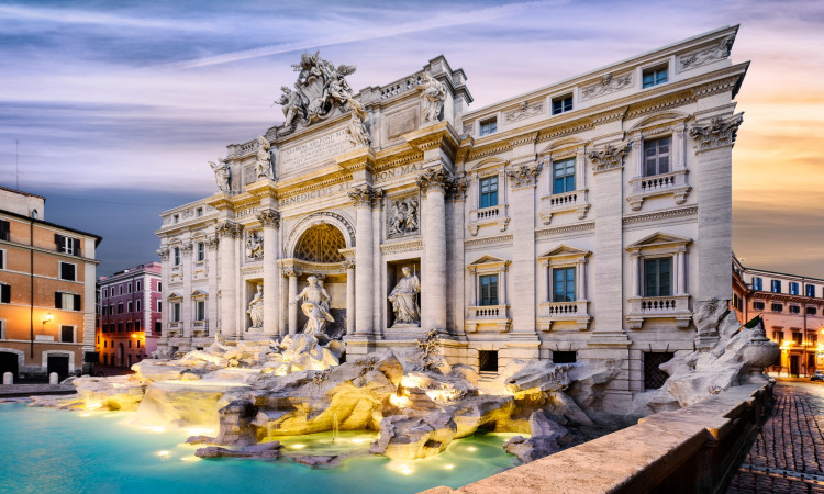 the majestic trevi fountain in the center of piazza di trevi, italy at sunrise. the marble architecture is illuminated by golden light, and water splashes can be seen from under the sculptures.